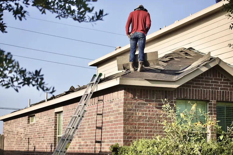 Professional roofer working on a residential roof in Bridge City